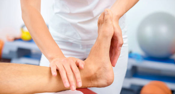 Physiotherapist performing rehabilitation exercises for compartment syndrome