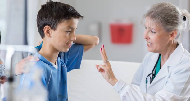 Female doctor conducting a concussion assessment on a young boy in hospital
