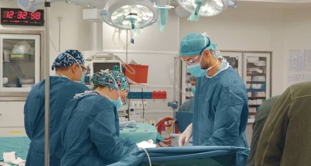 Surgeons performing heart surgery in a sterile operating theatre to treat congenital heart disease