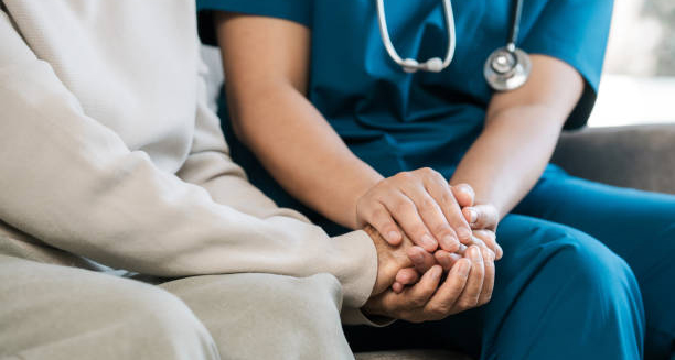 Nurse comforting an elderly patient during dementia care