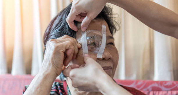 Elderly woman receiving eye protection after diabetic retinopathy treatment