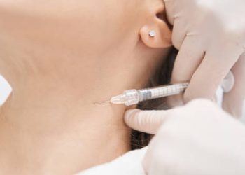 Close-up of a neck injection administered by a medical professional