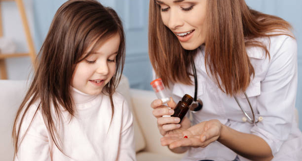 Female doctor showing medication to a young girl for early puberty treatment