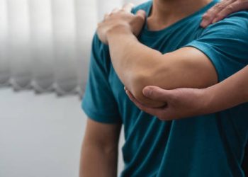 Physiotherapist assisting patient with joint support during treatment for Ehlers-Danlos Syndromes.