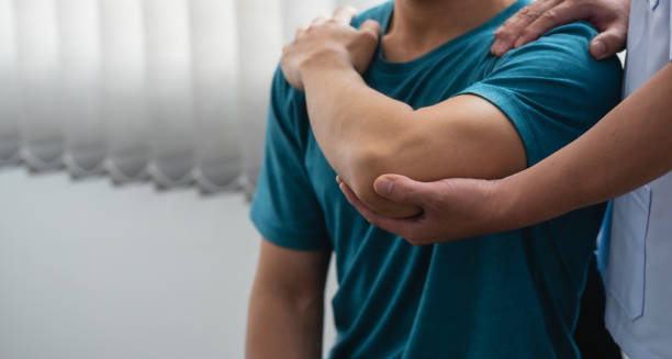 Physiotherapist assisting patient with joint support during treatment for Ehlers-Danlos Syndromes.
