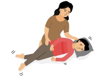 Mother helping child during febrile seizure recovery