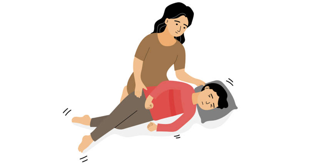 Mother helping child during febrile seizure recovery