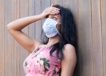 Woman in mask experiencing symptoms possibly linked to Group B Strep
