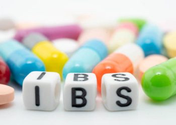 IBS treatment concept with colourful pills and cubes spelling IBS