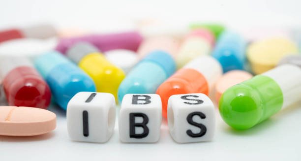 IBS treatment concept with colourful pills and cubes spelling IBS