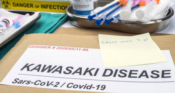 Medical folder labelled Kawasaki Disease with syringes and infection warning in a clinical setting