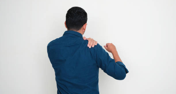 Man clutching his shoulder due to ongoing shoulder pain and stiffness