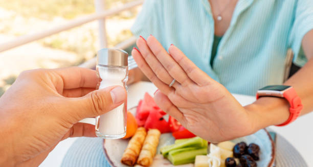 Person refusing salt to reduce complications from gout and manage uric acid levels