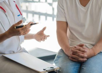 Doctor counselling a patient about complications of HIV infection