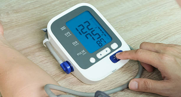 Digital blood pressure monitor showing readings during a cardiac health check