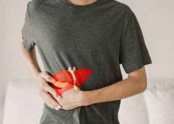 Person clutching abdomen showing possible liver complications from hepatitis A