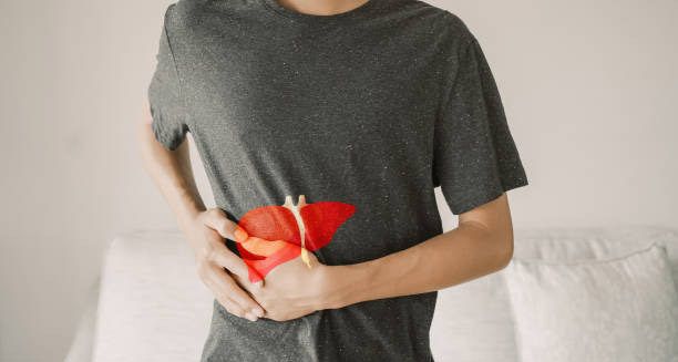 Person clutching abdomen showing possible liver complications from hepatitis A