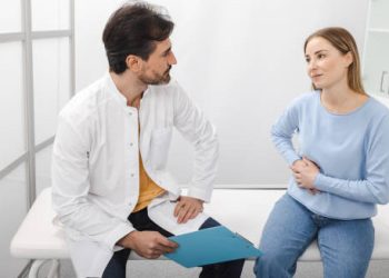 Doctor discussing liver complications of Hepatitis B with a female patien