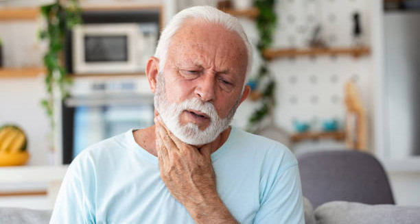 Elderly man experiencing neck pain, a possible complication of Hodgkin lymphoma