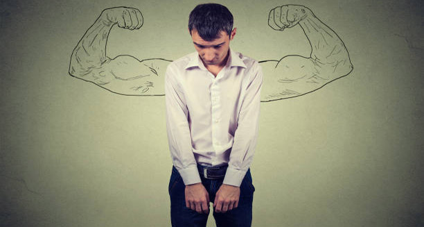 Sad man with drawn muscular arms symbolising hidden impotence struggles