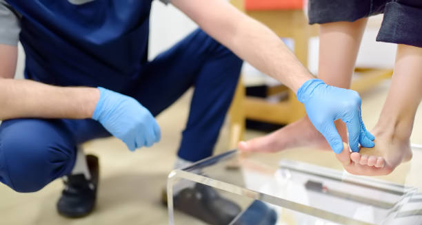 Podiatrist examining a child's foot for flat feet diagnosis