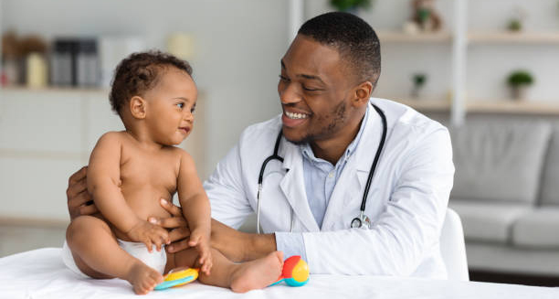 Doctor examining baby for signs of flat head syndrome