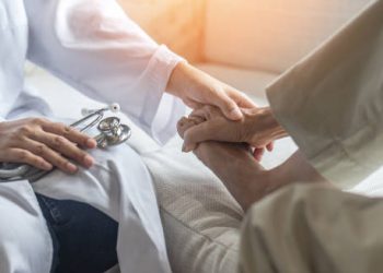 Doctor examining patient’s foot during a medical consultation