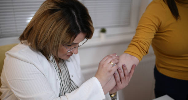 Doctor examining a patient's arm for grazes or skin injuries