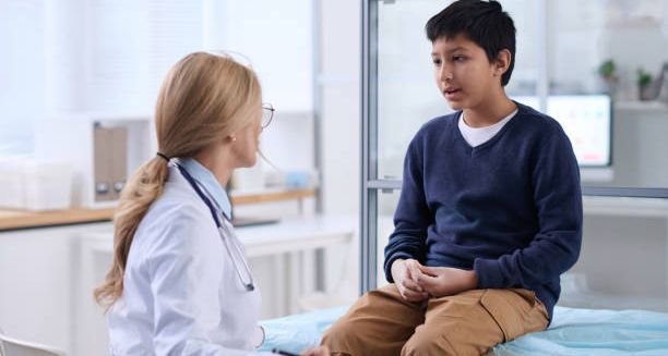 Doctor discussing growing pains diagnosis with a young boy