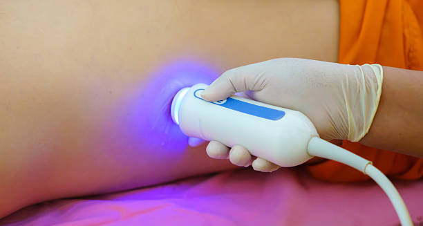 Ultrasound scan being performed on patient's side for haemochromatosis diagnosis