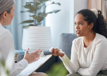 Woman speaking with a mental health professional during a therapy session