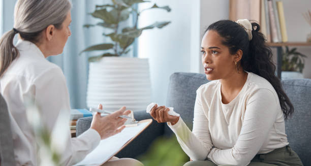 Woman speaking with a mental health professional during a therapy session