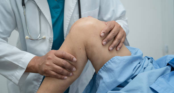 Doctor examining patient's leg for neuromuscular symptoms linked to hereditary spastic paraplegia
