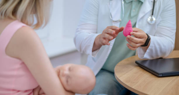 Paediatric doctor explaining diagnostic tools for Hirschsprung’s disease to mother with infant