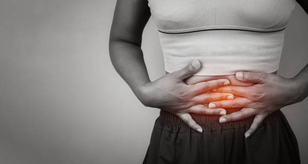 Woman clutching lower abdomen due to gastritis pain