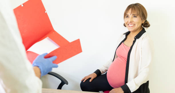 Pregnant woman consulting doctor about Group B Strep screening