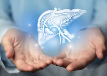 Doctor holding a glowing digital liver illustration, representing Hepatitis B awareness and liver health