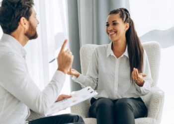 Smiling woman in therapy session showing positive outlook for health anxiety recovery