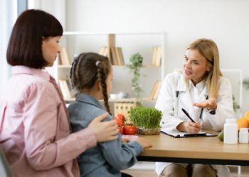 Doctor discussing long-term care and dietary guidance with a mother and daughter