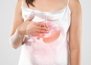 Woman holding chest with digestive illustration showing hiatus hernia condition