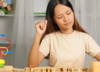 Young woman engaging in developmental therapy activities, representing the long-term outlook for hydrocephalus.