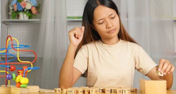 Young woman engaging in developmental therapy activities, representing the long-term outlook for hydrocephalus.