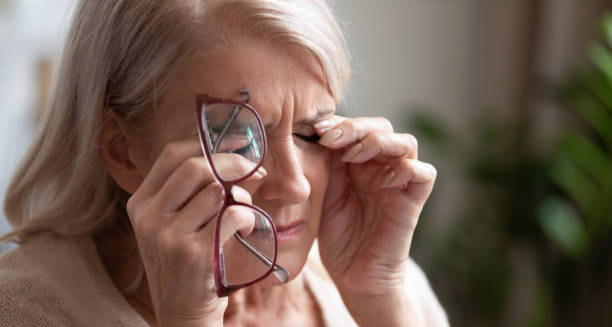 Elderly woman experiencing eye discomfort due to hypoparathyroidism