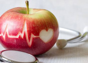 Apple with heartbeat and heart icon symbolising heart disease prevention