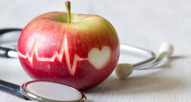 Apple with heartbeat and heart icon symbolising heart disease prevention