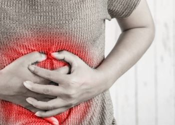 Person clutching stomach in pain with red highlight indicating abdominal discomfort