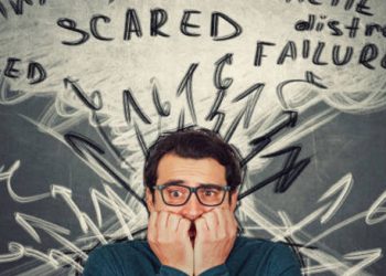 Anxious man surrounded by scribbled thoughts and words like “scared” and “failure”