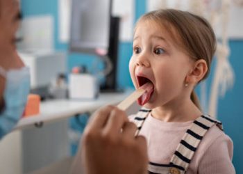 Child being examined by doctor during a check-up for growing pains