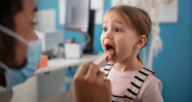 Child being examined by doctor during a check-up for growing pains