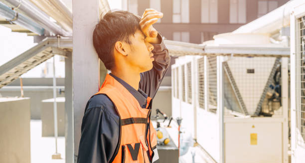 Worker showing visible symptoms of heat exhaustion under extreme heat